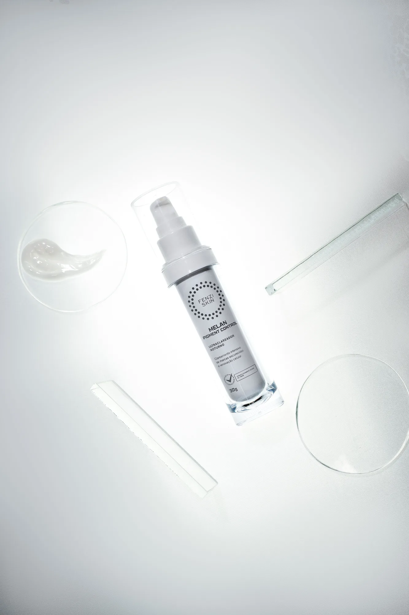 A skincare bottle with clear glass dishes
