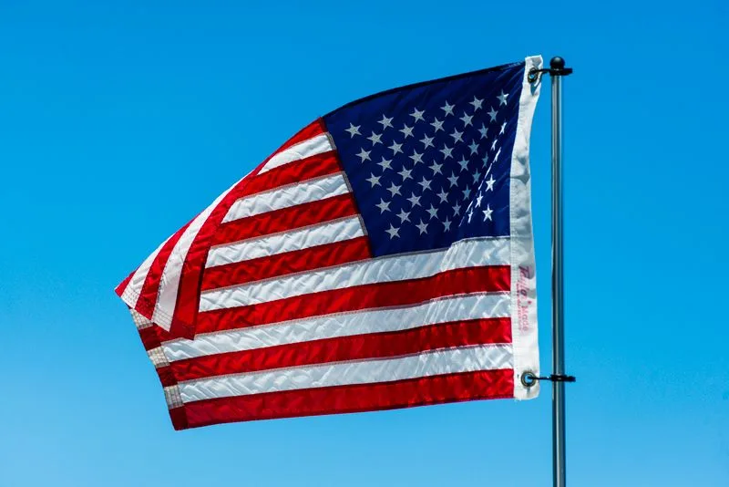 3x5 nylon American flag flying against blue sky
