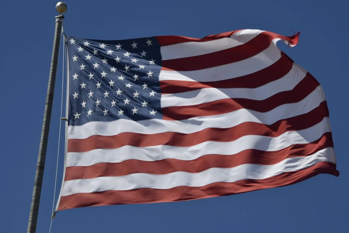 American flag waving against blue sky