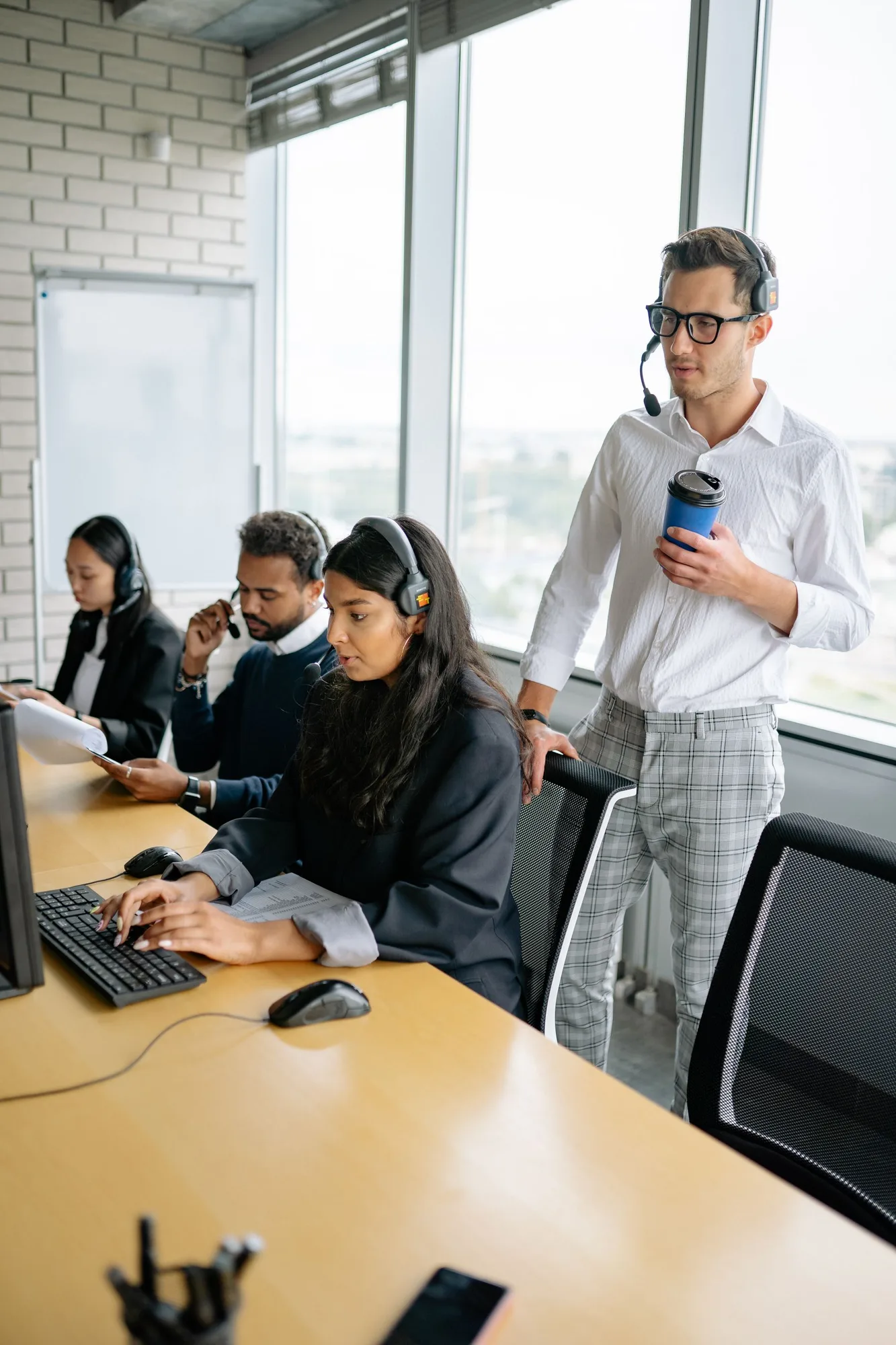 Colleagues discussing a computer screen in an office