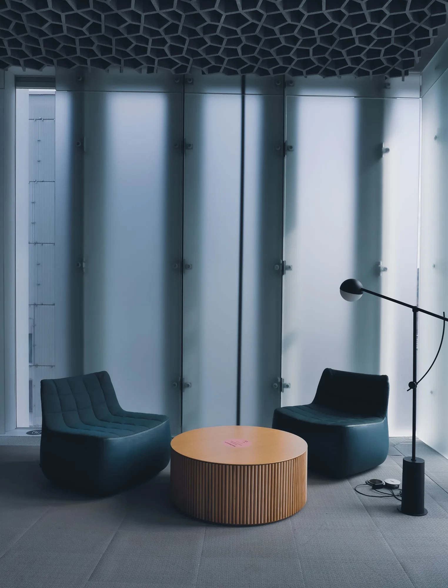 Modern armchairs with a low table and standing lamp