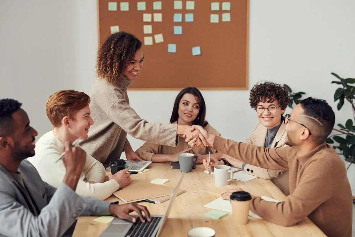 Colleagues discussing work around a table