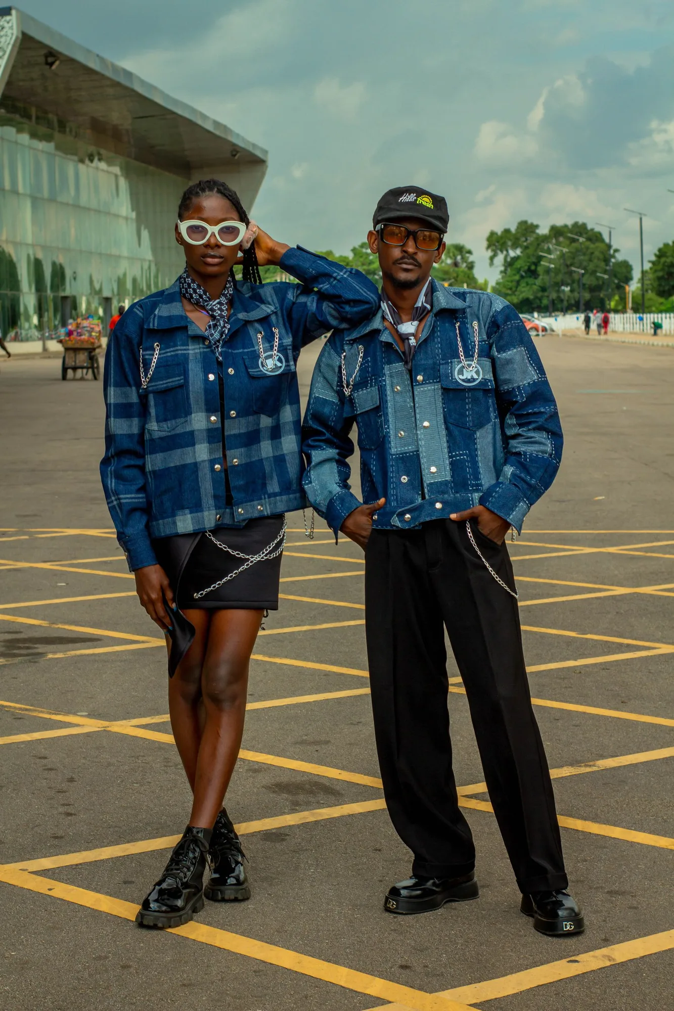 Two people wearing expressive denim outfits in an urban setting