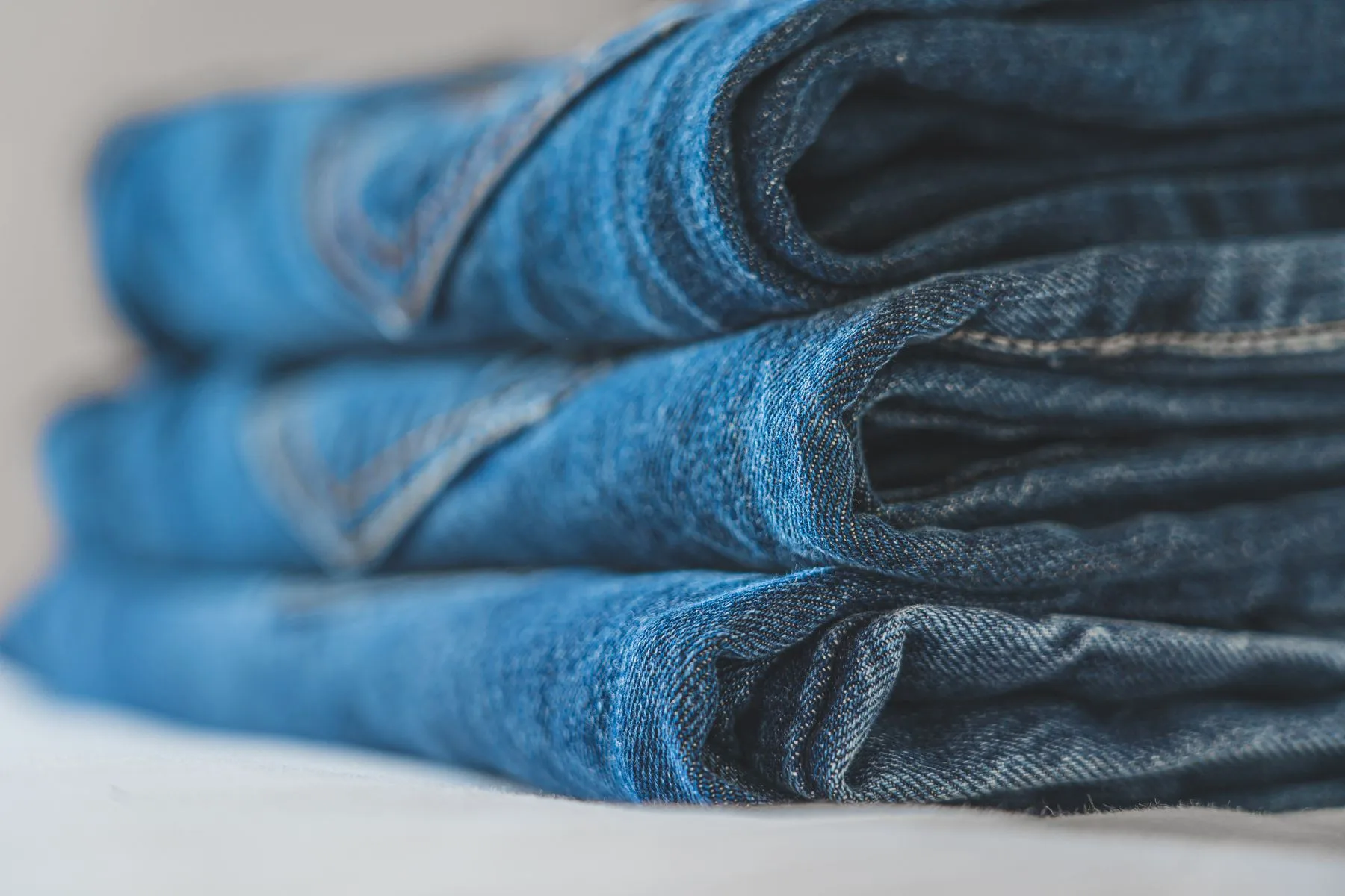 Folded blue denim showing seams and texture