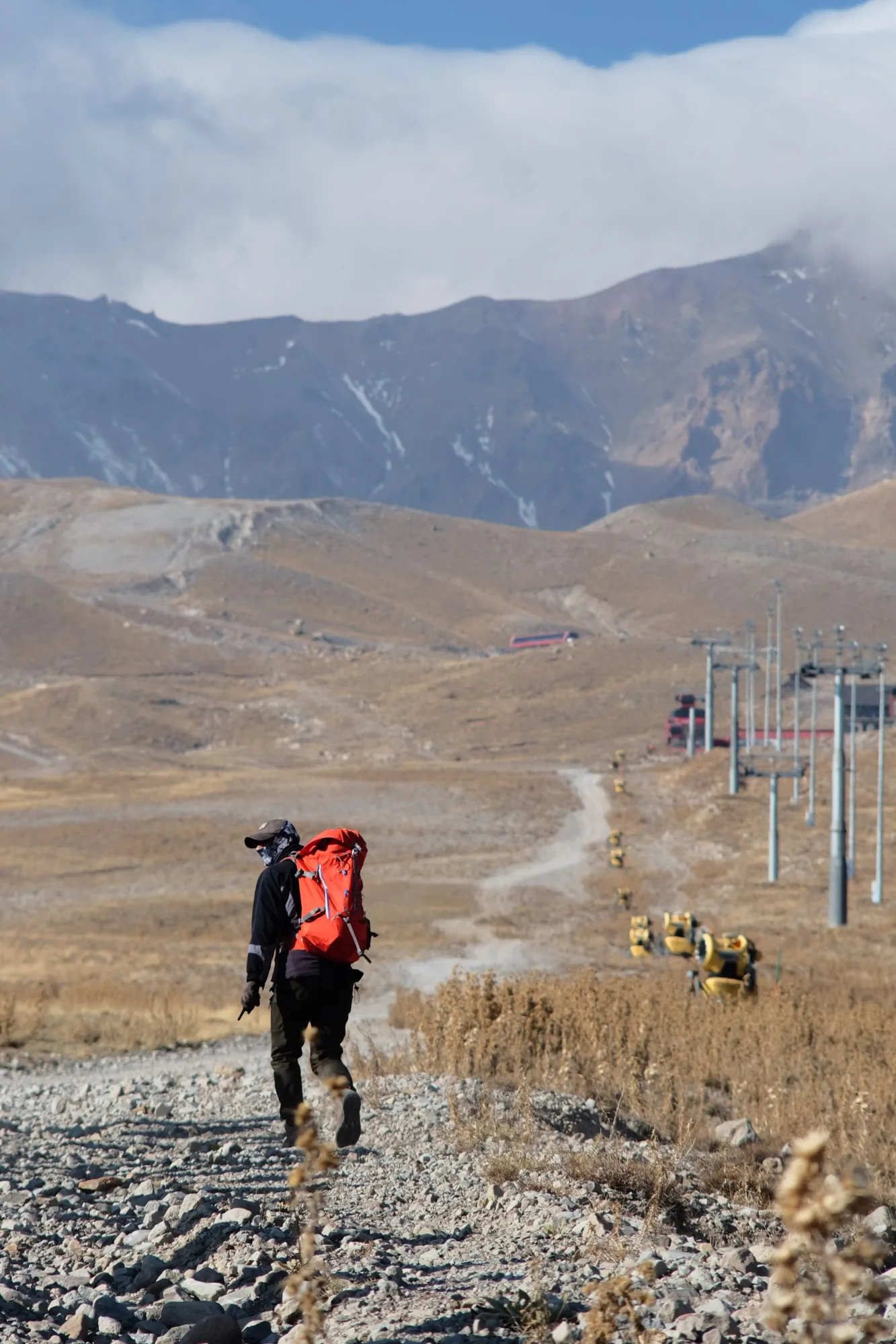 Hiker walking toward an open mountain landscape