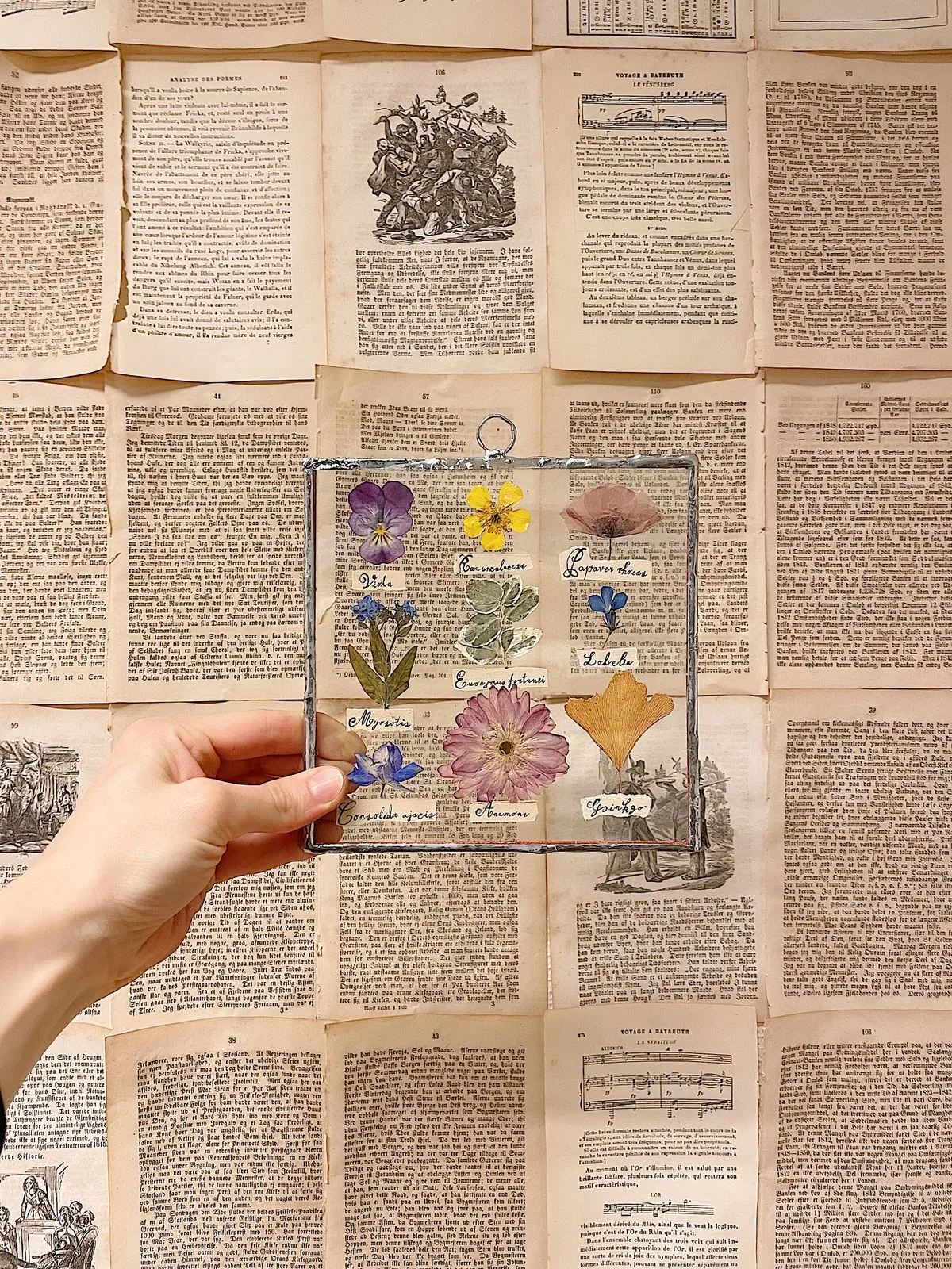 Hands arranging dried flowers for a custom commission
