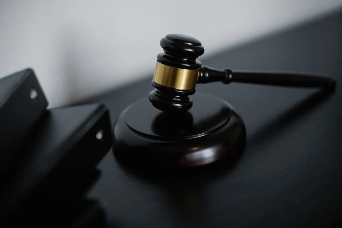 Judge’s gavel on a dark desk