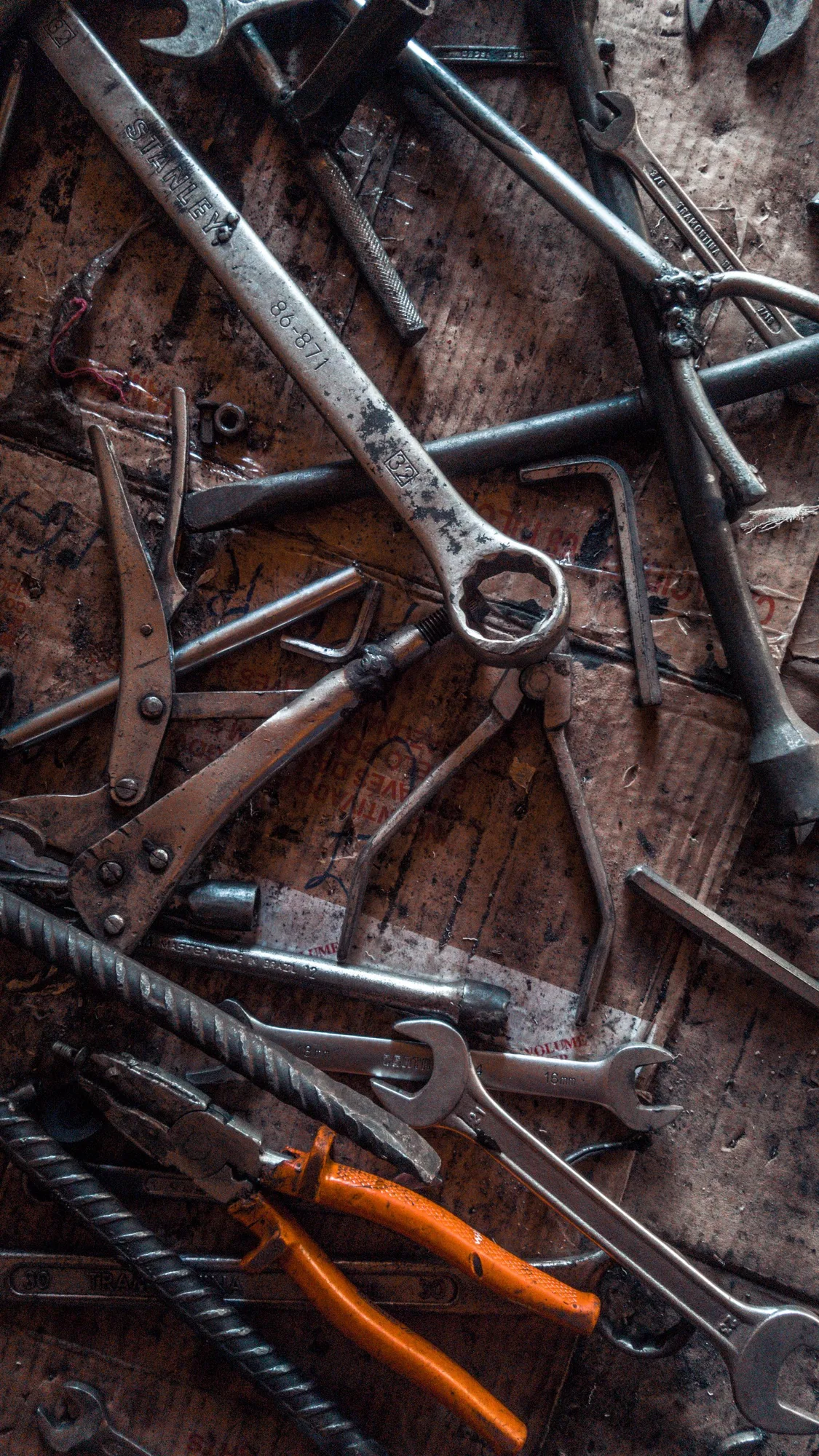 Metal hand tools arranged on a workshop surface