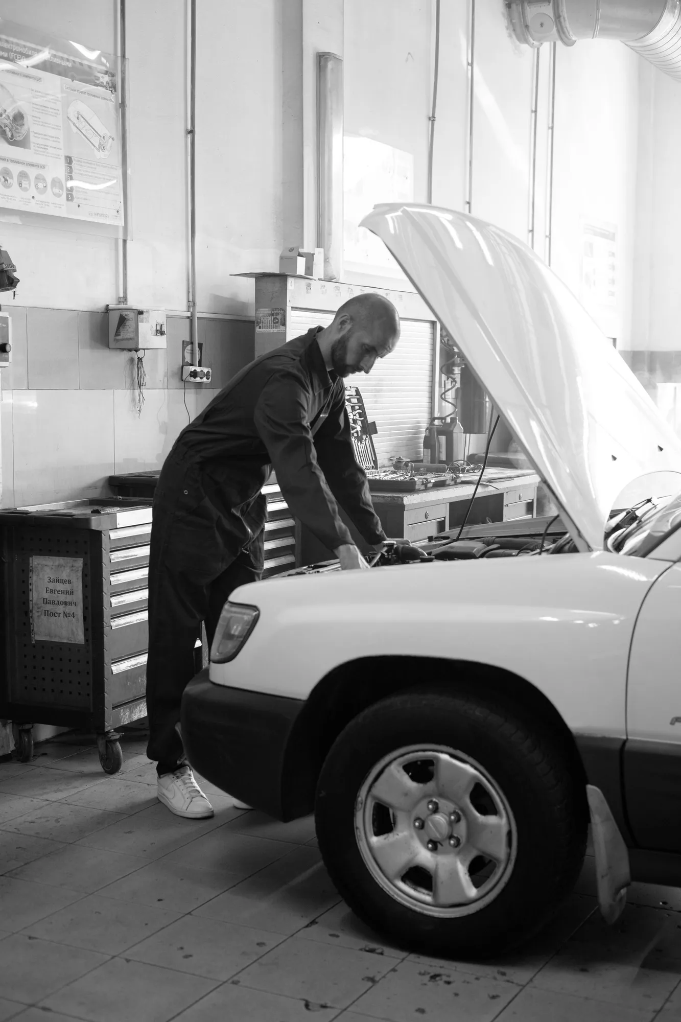 Mechanic inspecting a car in a workshop